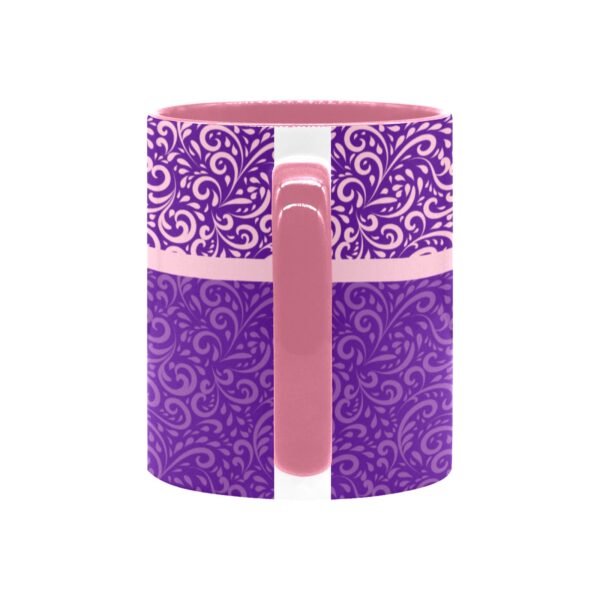 Decorative purple patterned coffee mug with pink handle.