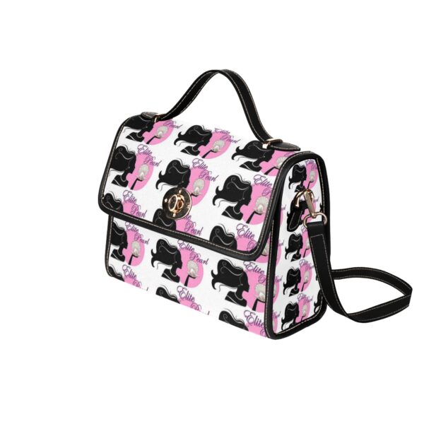 Designer dog pattern handbag with shoulder strap.