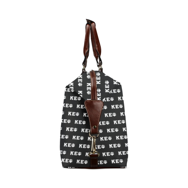Designer monogrammed handbag with leather straps.
