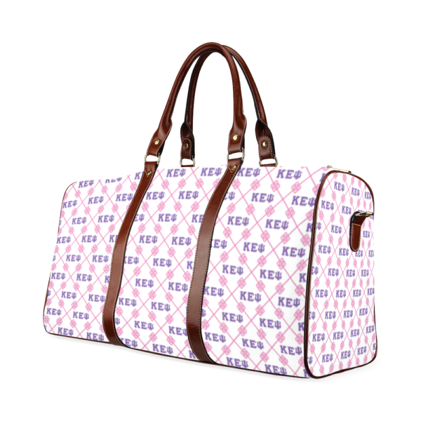 Pink patterned travel bag with brown leather handles.