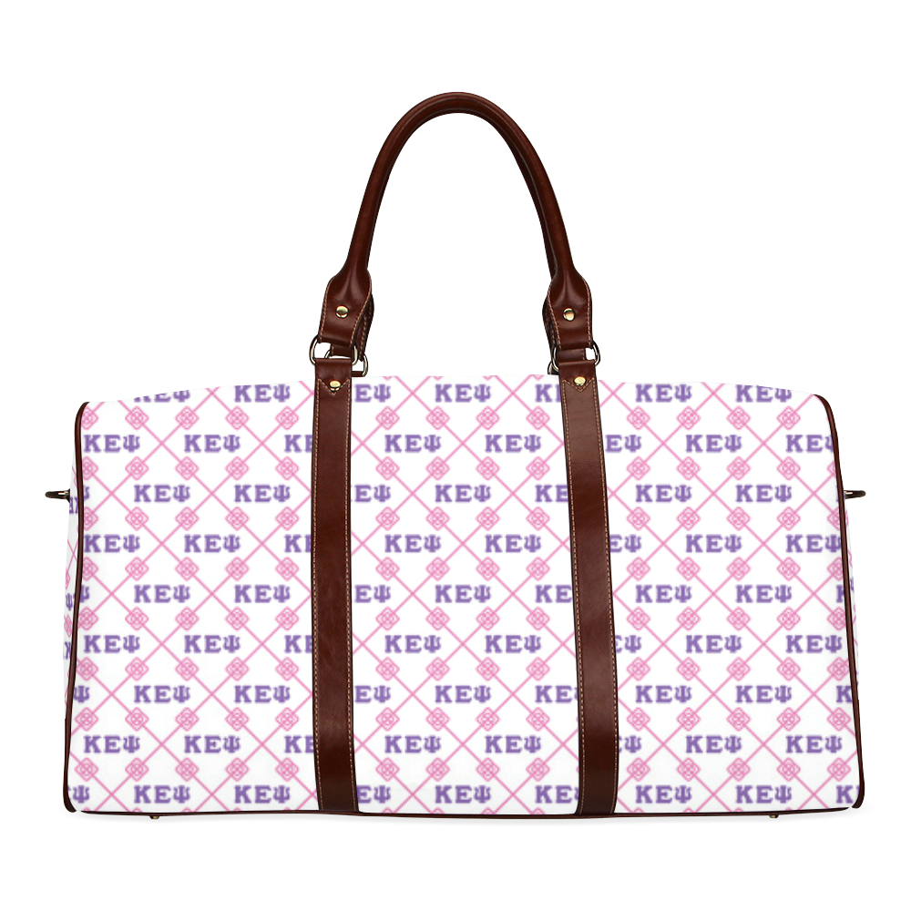 Patterned travel bag with brown leather straps.