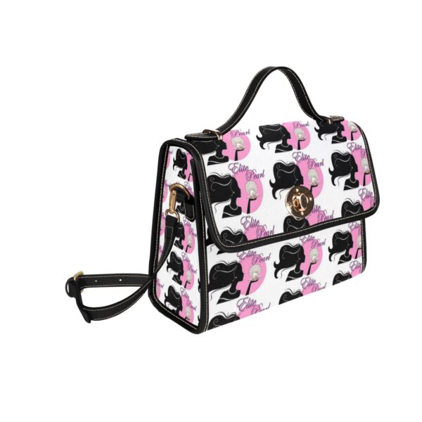 Patterned designer handbag with poodle motifs and strap.