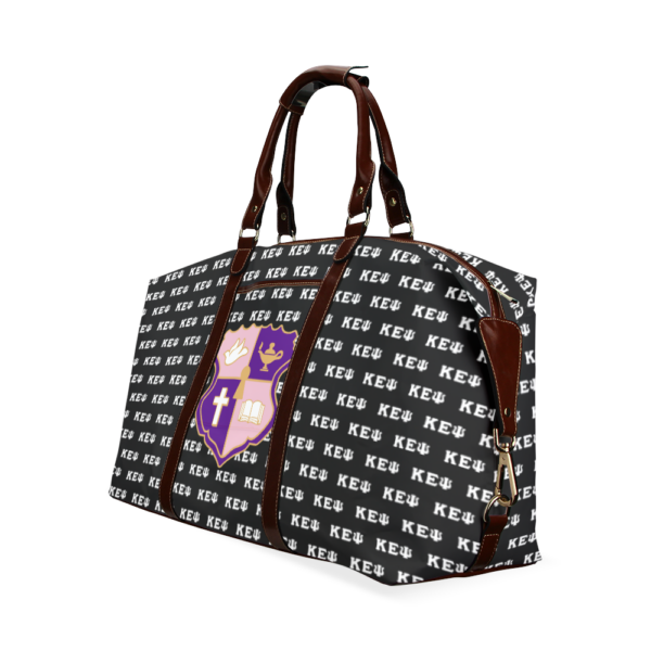 Designer patterned tote bag with brown leather straps.