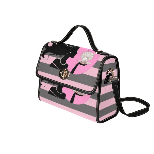 Pink striped handbag with floral accent.